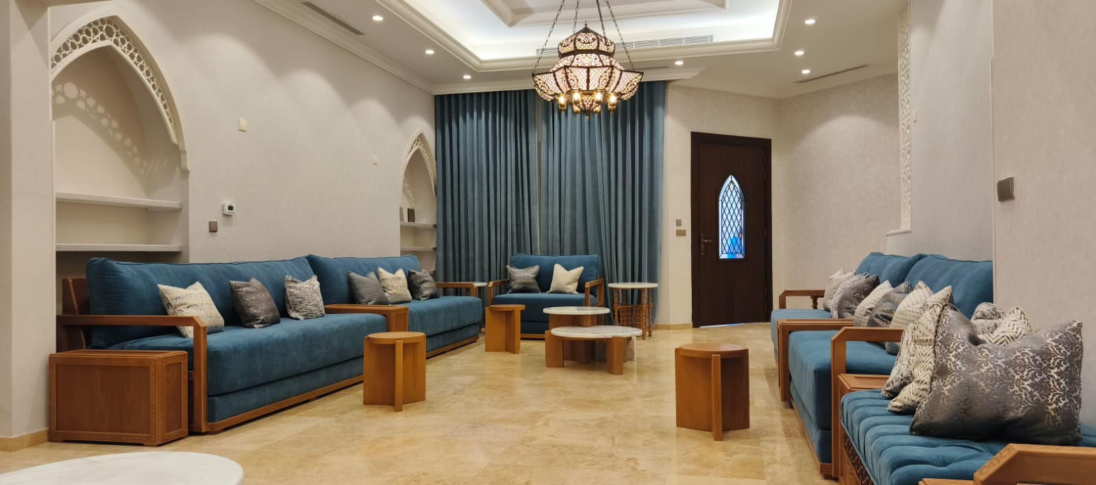 مجلس عربي بجلسات زرقاء وأقواس جصية من تجهيز Huge Home